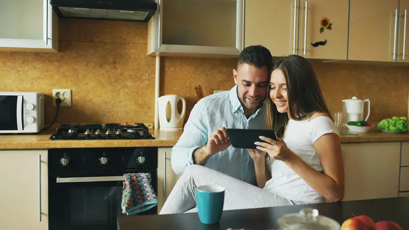 Couple reviewing their budget together in the kitchen